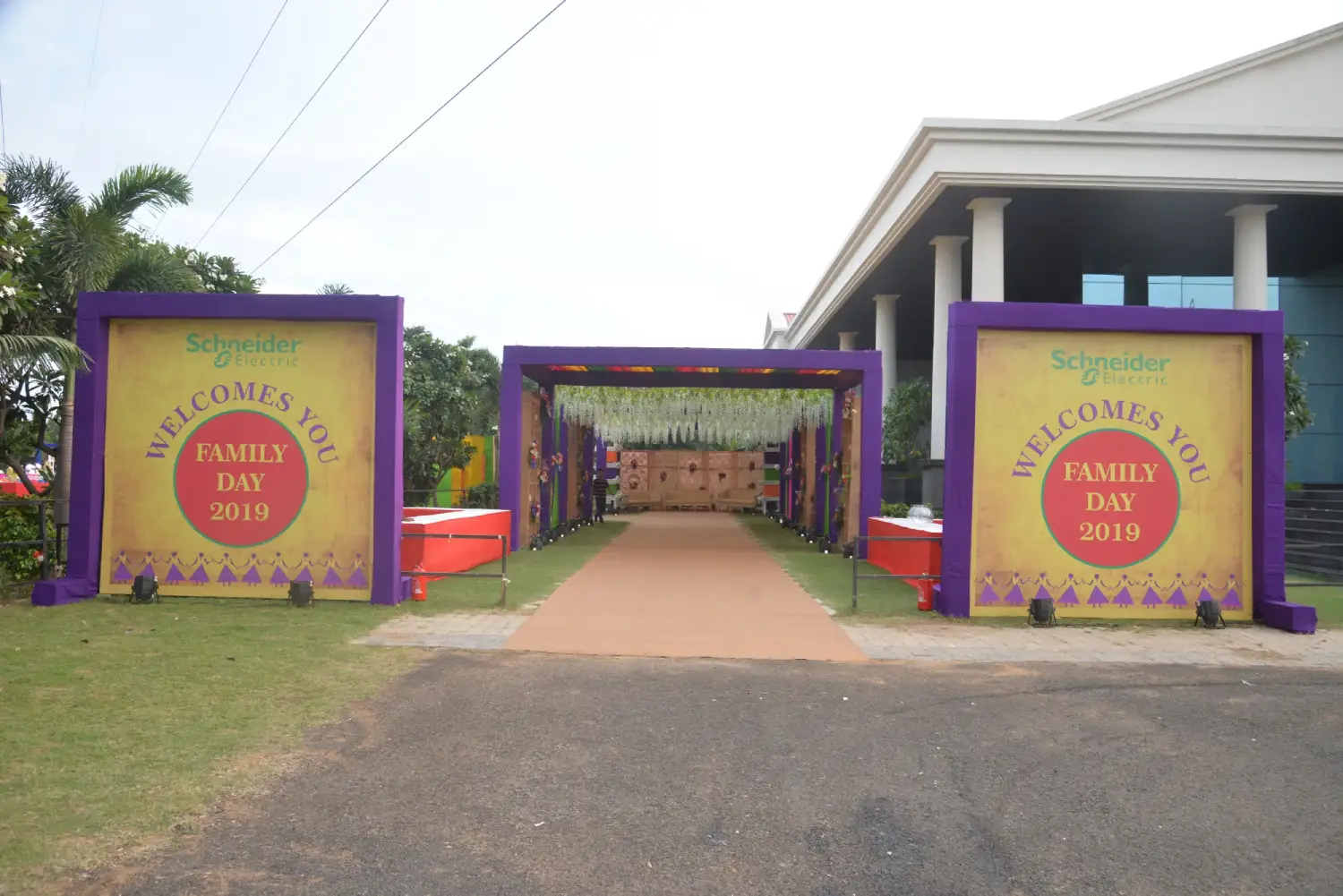 ITT event entrance with red and green carpet and pink lighting on white structure with ITT branding